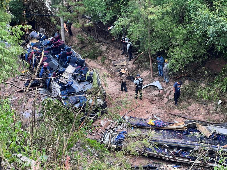 Các nhà chức trách và tình nguyện viên làm việc tại địa điểm nơi một chiếc xe buýt đâm vào khe núi làm nhiều người thiệt mạng ở Magdalena Penasco (Mexico). (Ảnh: REUTERS/Jose de Jesus Cortes)