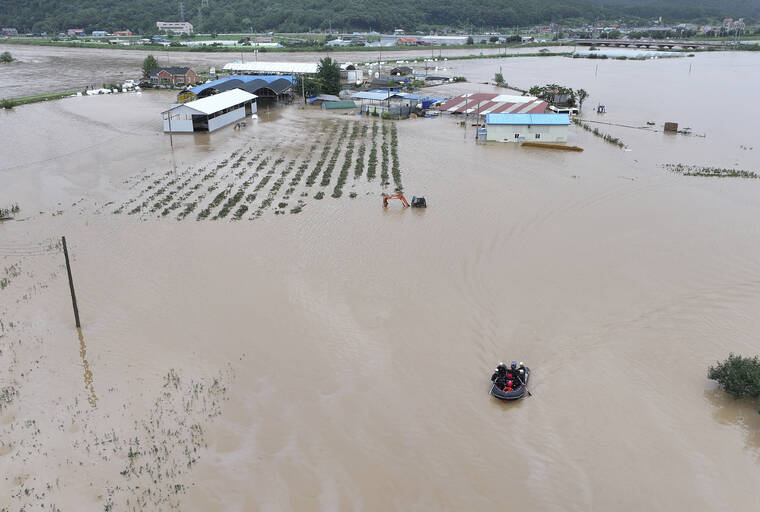 Lực lượng cứu hộ tìm kiếm những người mất tích trong dòng nước lũ ở Daegu (Hàn Quốc).