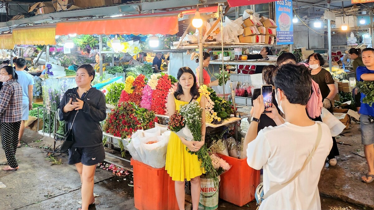 Nhiều người tới mua hoa về cắm, nhiều người lại chọn khu chợ như một điểm tham quan, ngắm hoa, chụp ảnh... Ảnh Trịnh Anh