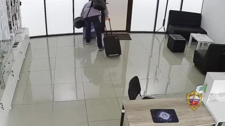 Người đàn ông này đã nhét hàng chục chiếc điện thoại iPhone vào một chiếc vali nhỏ cùng vài chiếc túi.