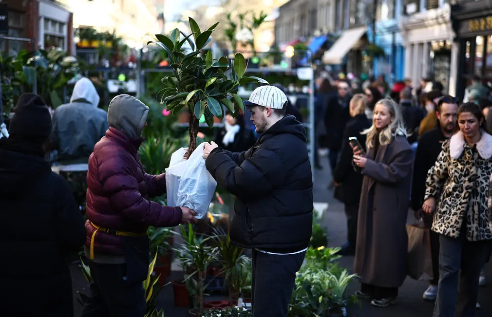Người đàn ông mua một chậu cây tại chợ hoa Columbia Road (London, Vương quốc Anh). (Ảnh: Henry Nicholls/AFP/Getty Images)