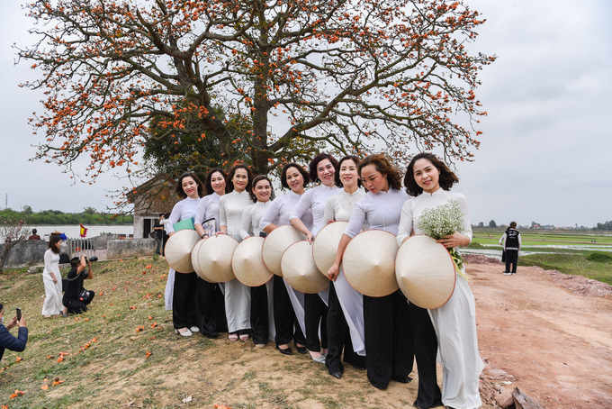 Rất đông các chị em phụ nữ mang tà áo dài thướt tha đến chụp ảnh check-in lưu lại những kỷ niệm tháng 3 bên cây gạo song sinh cổ thụ.