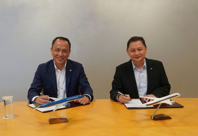 Tổng Giám đốc Vietnam Airlines Lê Hồng Hà (trái) và Tổng giám đốc Singapore Airlines Goh Choon Phong (phải) kí kết Biên bản ghi nhớ về tăng cường hợp tác song phương tại Singapore vào ngày 9/2/2023