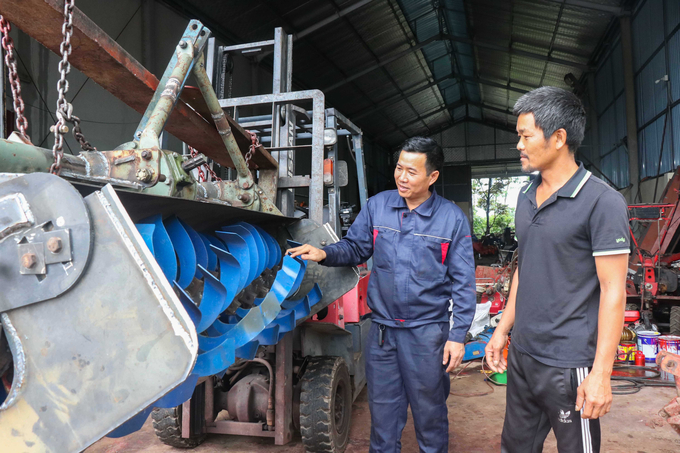 Anh Phùng Văn Nam (bên trái) giới thiệu sản phẩm máy cày phay lên luống đến với bà con nhân dân.