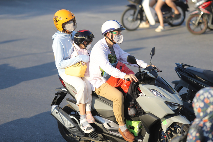 Dòng người rời thủ đô về quê nghỉ lễ, một gia đình lựa chọn hình thức di chuyển bằng xe máy