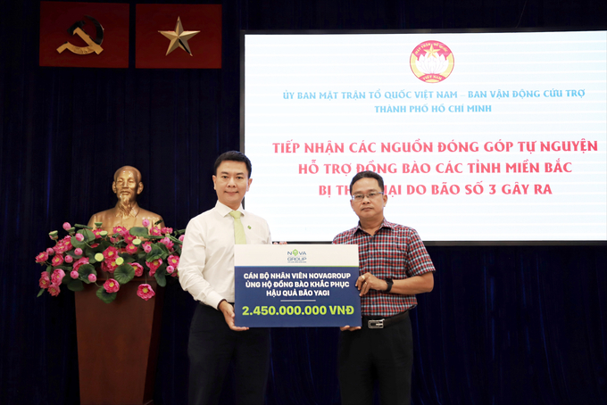 Ông Phạm Minh Tuấn – Phó Chủ tịch Ủy ban MTTQ Việt Nam TP.HCM nhận bảng trao ủng hộ 2,45 tỷ đồng từ ông Sĩ Danh Quốc Hưng (bên trái) – Giám đốc Ban Nhân sự, đại diện Tập đoàn NovaGroup