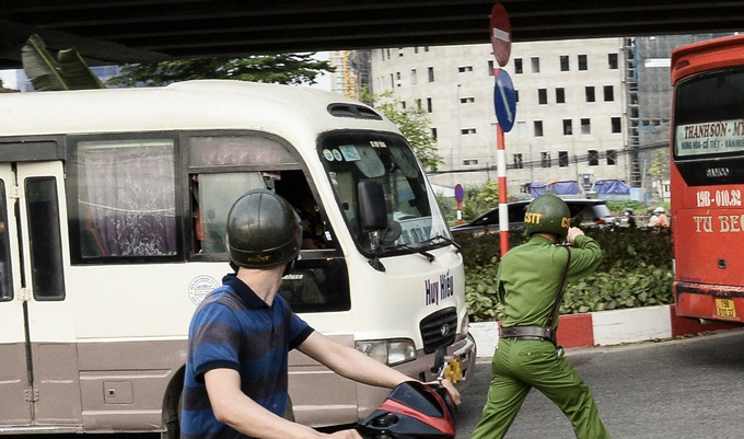 Một cán bộ chiến sĩ thuộc Đội cảnh sát Trật tự - Công an quận Nam Từ Liêm ra hiệu dừng chiếc xe khách này để kiểm tra. Tuy nhiên, chiếc xe này bất chấp nhấn ga bỏ chạy.