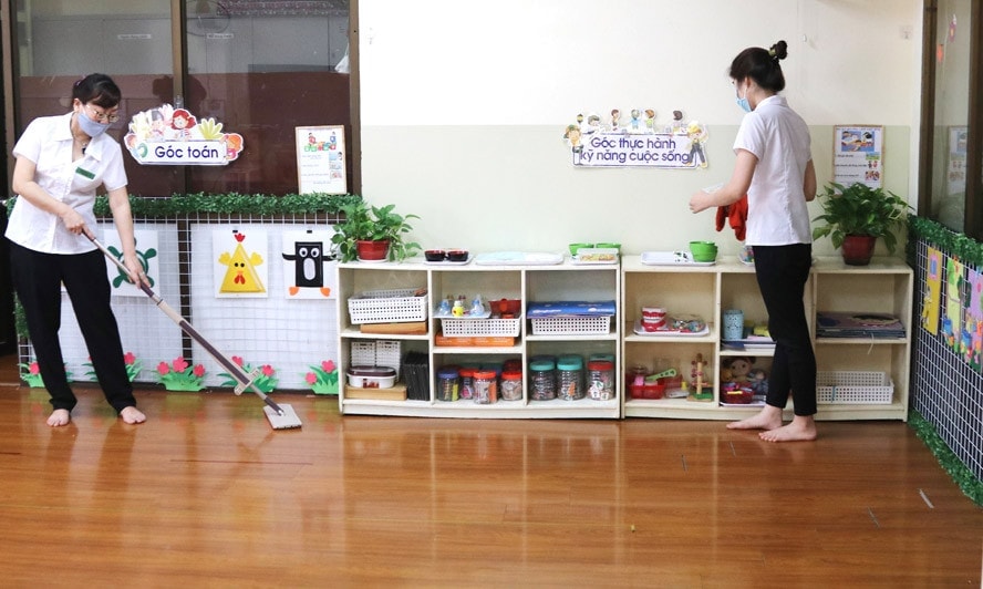 Giáo viên Trường Mẫu giáo số 3 (quận Ba Đình) vệ sinh lớp học, khử khuẩn dụng cụ, đồ chơi để phòng bệnh tay chân miệng. Ảnh: Đỗ Tâm