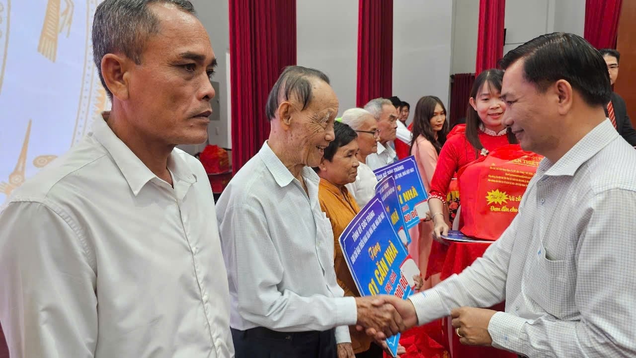  Ông Trần Văn Lâu, Chủ tịch UBND tỉnh Sóc Trăng tặng quà cho các hộ được nhận nhà tại hội nghị - Ảnh: L.X.C