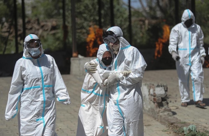 Người thân và các nhân viên y tế tại một khu vực hỏa táng người chết vì Covid-19 ở Jammu, Ấn Độ vào ngày 25 tháng 4 năm 2021. Ảnh: AP