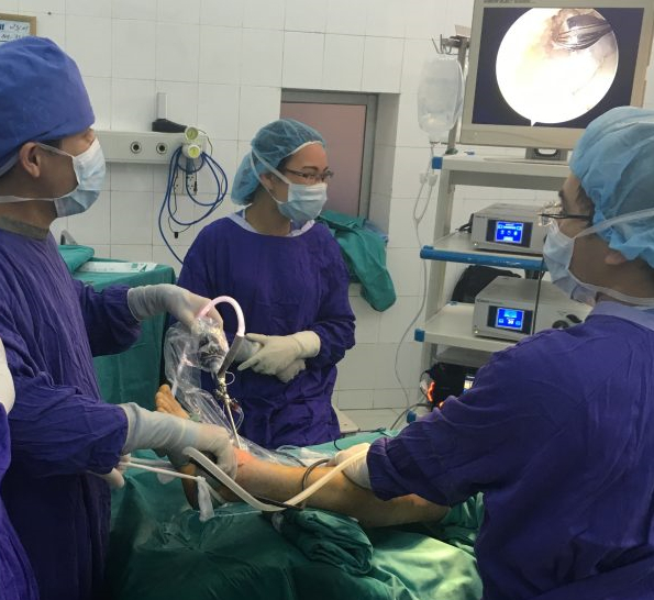   Các bác sĩ tiến hành phẫu thuật nội soi điều trị chấn thương ở cổ chân cho bệnh nhân  