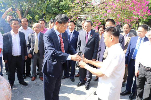   Ông Nguyễn Văn Công (phải) trao ngọn lửa thiêng và lá quốc kỳ được xin từ ban thờ Bác tại nhà H67 cho đại diện doanh nhân  