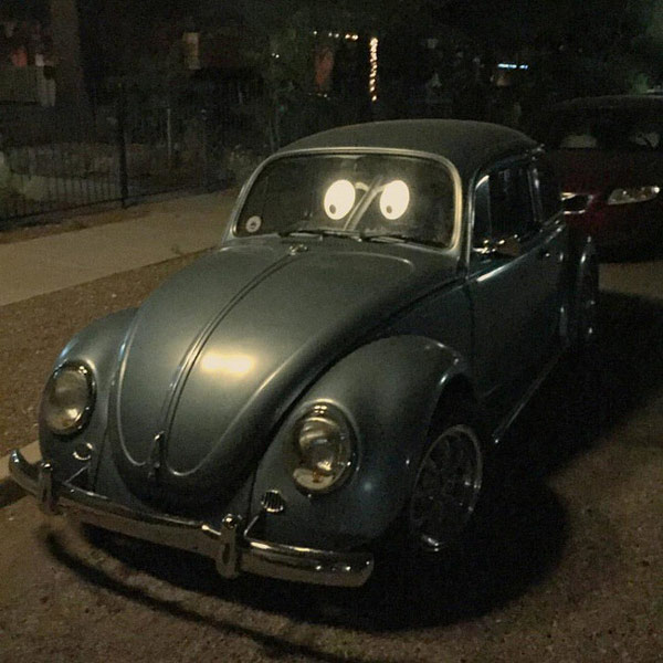   Đèn đường phản chiếu qua tấm kính ô tô khiến chiếc xe trông giống như có đôi mắt đang nhìn vào bạn vậy.  