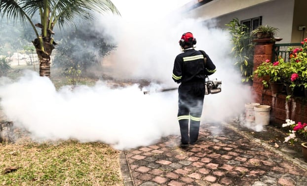 Worker-fogging-residential-area