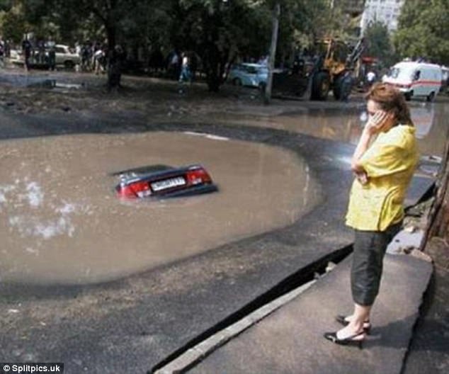 Chỉ còn biết đứng hát 'Em đi sâu quá' và đợi xe cứu hộ, người phụ nữ này không hề hình dung được vũng nước lại ẩn chứa một cái hố bên dưới. 
