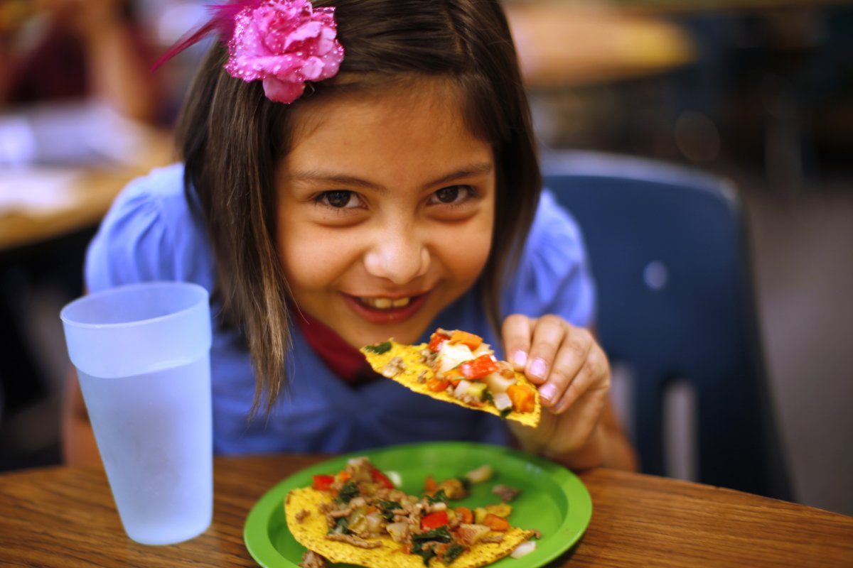 denver-colorado-a-student-in-the-munroe-elementary-school-gardening-club-enjoys-a-taco-she-helped-prepare-by-growing-and-chopping-vegetables