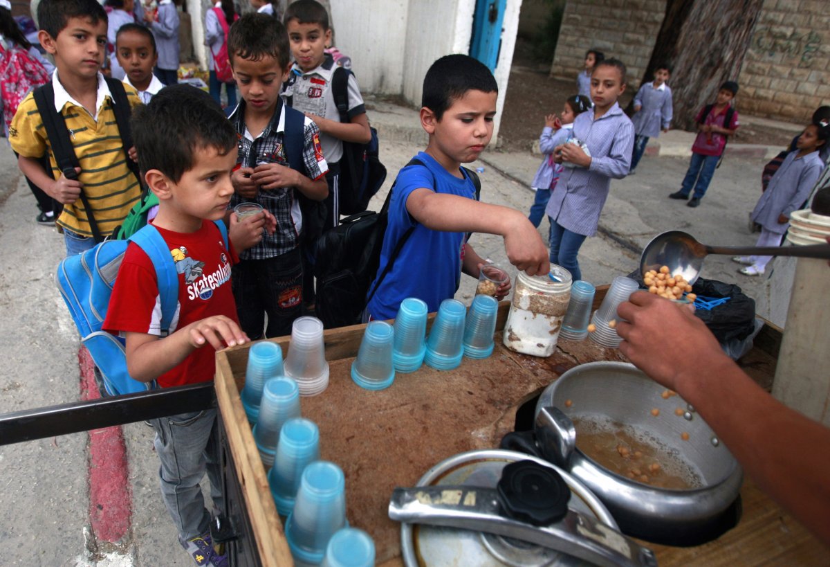 jenin-refugee-camp-palestine-children-buy-chickpeas-from-a-street-vendor-in-front-of-a-school-that-belongs-to-the-united-nations-relief-and-works-agency