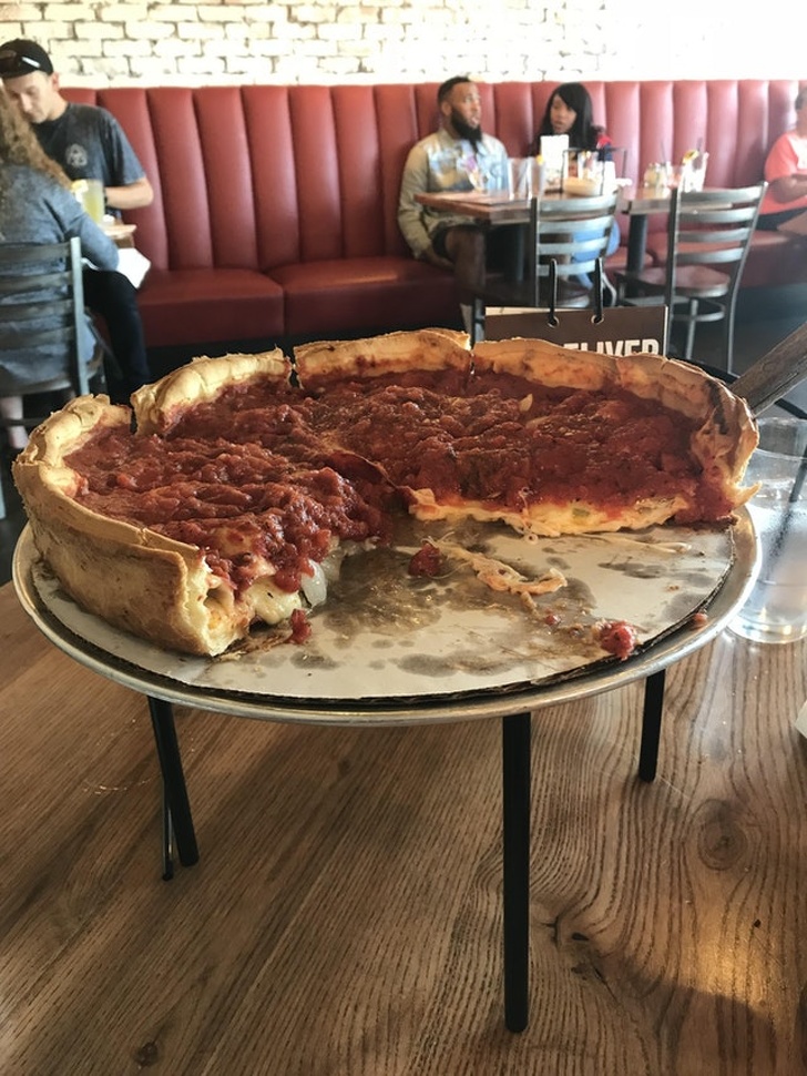 Chụp chiếc pizza trên khay cắt bánh, góc độ này khiến nó như một chiếc pizza khổng lồ