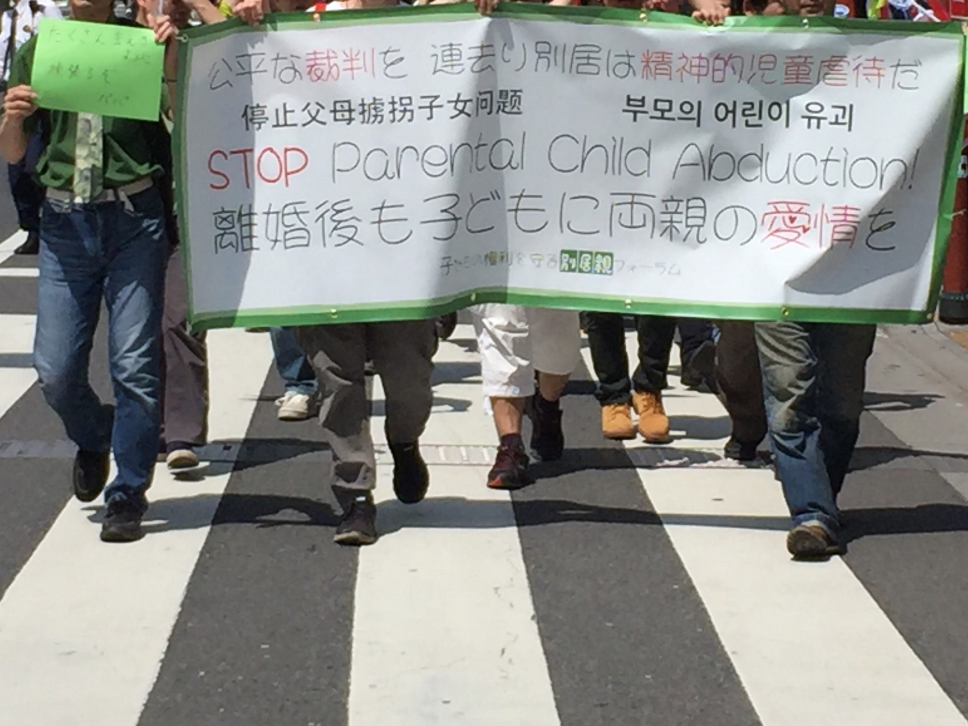 Những biểu ngữ 'Chấm dứt việc bắt cóc con!' bằng nhiều thứ tiếng trong cuộc diễu hành