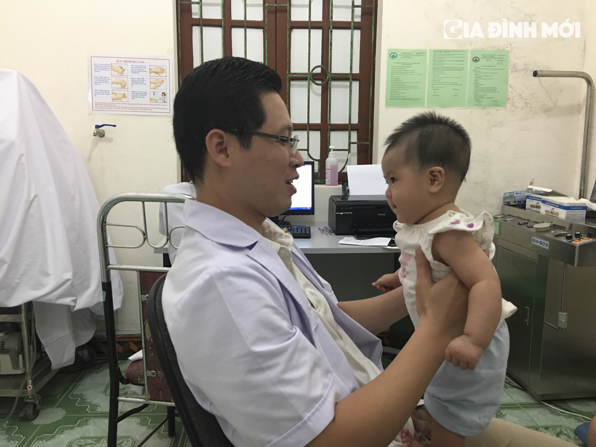 Bác sĩ Phạm Văn Nam trêu đùa em bé trước khi thực hiện khám