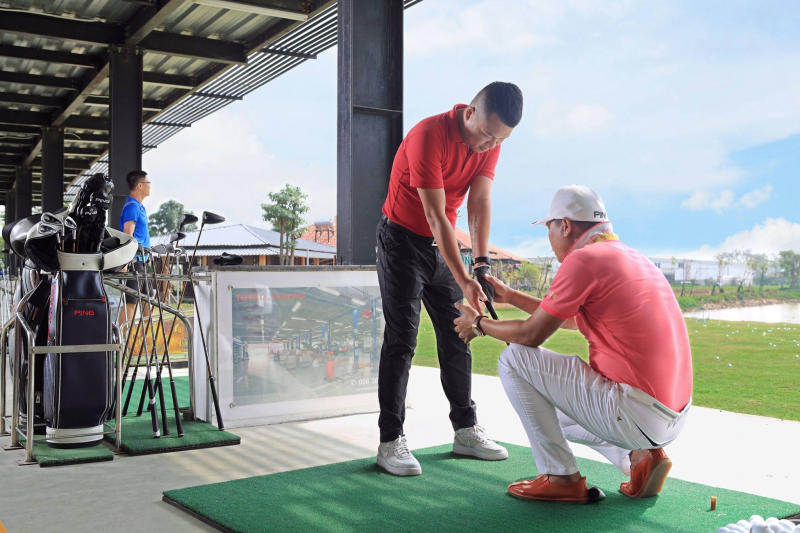 Golfer Nguyễn Văn Bằng (ngồi) hướng dẫn học viên