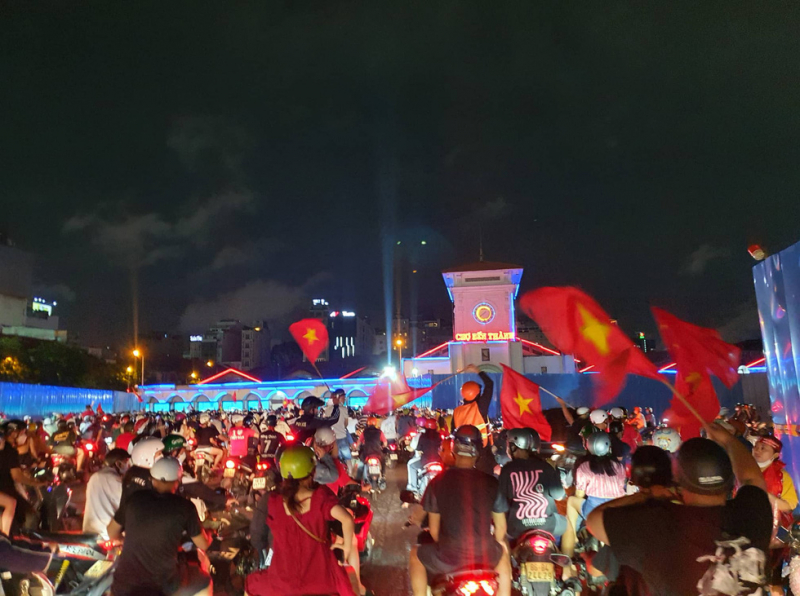 Cảnh người hâm mộ ra đường ăn mừng chiến thắng trước chợ Bến Thành, TP. HCM (ảnh: Minh Hoà)