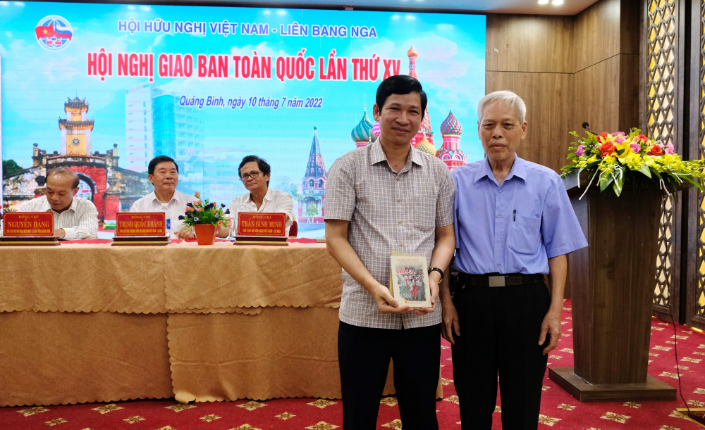 Đại tá, Anh hùng LLVTND Nguyễn Quang Hùng (bên phải) trao tặng Phó Chủ tịch UBND tỉnh Quảng Bình Hồ An Phong cuốn sách của ông “Sam-2 vít cổ B-52 như thế đấy”  Ảnh: PHẠM TIẾN DŨNG