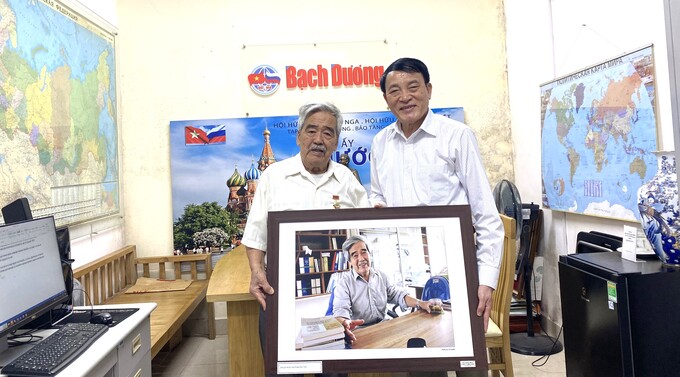 Ông Nguyễn Đăng Phát trao bức ảnh chân dung dịch giả  do nhà báo, nghệ sĩ nhiếp ảnh Vũ Huyến chụp, tặng ông Hoàng Thuý Toàn