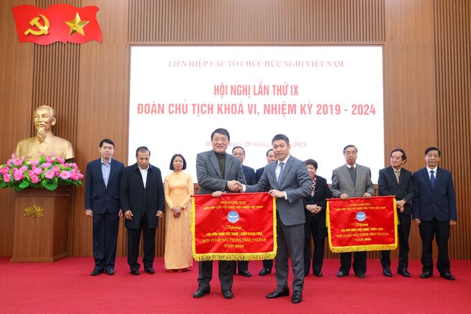 Phó Chủ tịch kiêm Tổng thư ký Hội Hữu nghị Việt - Nga Nguyễn Đăng Phát nhận Cờ thi đua do Chủ tịch Liên hiệp hữu nghị Phan Anh Sơn (bên phải) trao.