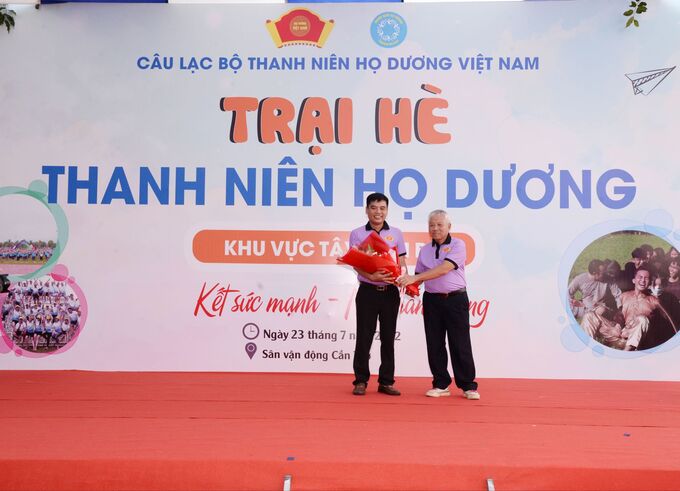 Ông Dương Quốc Trọng - Phó Chủ tịch Thường trực Hội đồng Họ Dương Việt Nam trao hoa cho ông Dương Hoàng Hai - Trưởng ban tổ chức trại hè.