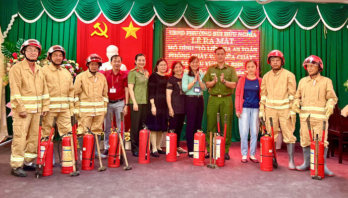Thiếu tá Nguyễn Xuân Đức, Phó Trưởng Công an quận Bình Thuỷ trao bình chữa cháy cho các thành viên Tổ liên gia an toàn PCCC khu vực 3, phường Bùi Hữu Nghĩa