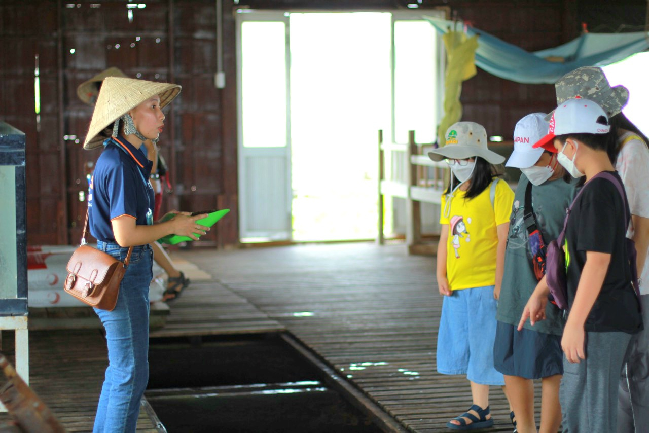 Nhân viên FME.travel hướng dẫn khách tham quan tại Du lịch cộng đồng Cồn Sơn, quận Bình Thủy, TP. Cần Thơ.
