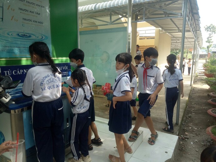 Các em học sinh trường THCS Lê Quý Đôn thường xuyên sử dụng nước sạch từ hệ thống máy lọc nước.