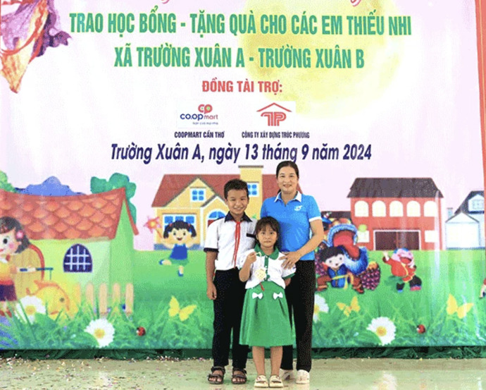 Chị Kim Cương dẫn 2 con đi nhận học bổng.