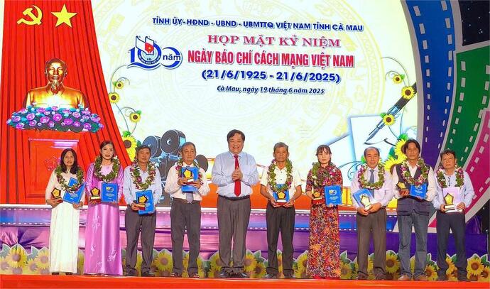 Chủ tịch UBND tỉnh Cà Mau Phạm Thành Ngại (giữa) trao thưởng cho các tác giả đoạt Giải Báo chí Nguyễn Mai nhân buổi họp mặt.