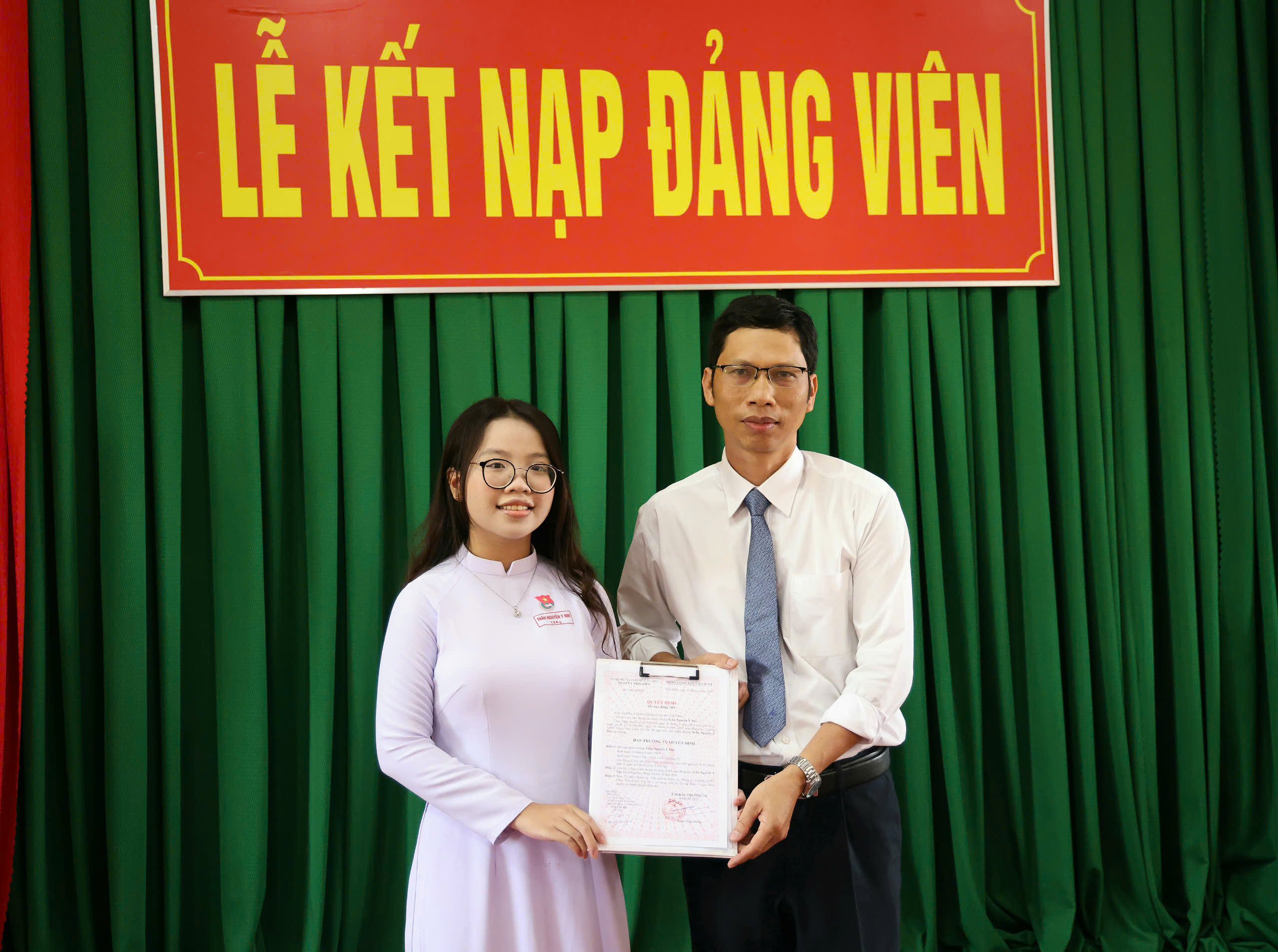 Thực hiện nghi thức trao quyết định kết nạp cho Đảng viên mới.