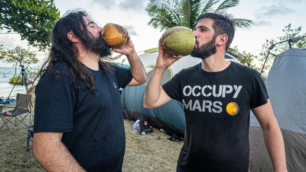http_cdn.cnn.com_cnnnext_dam_assets_220308151518_two_investors_drinking_rum_coconuts_to_celebrate_their_arrival_on_islandia