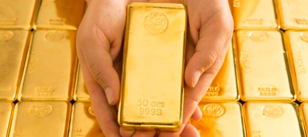 50oz-gold-cast-bar-in-hands