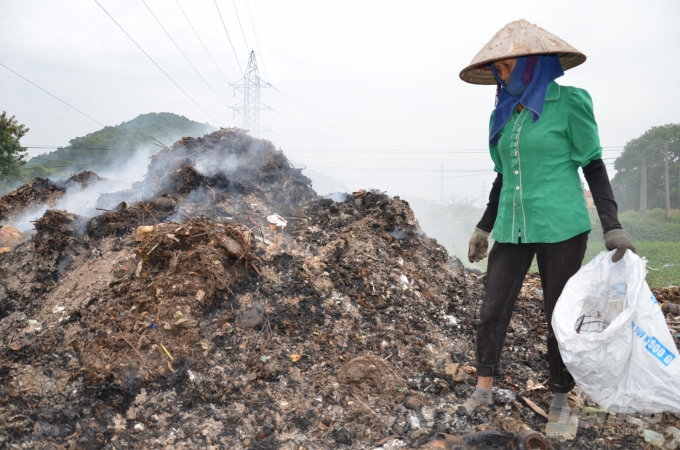 Một người dân đi bới rác ở bãi của làng tại xã Hoàn Sơn, huyện Tiên Du. Ảnh: Dương Đình Tường.