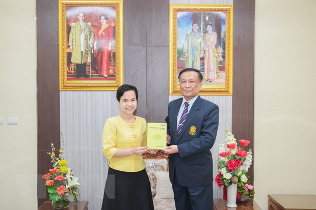 Tiến sỹ Trương Thị Hằng trao tượng trưng hơn 100 cuốn sách cho PGS. TS. Kittisak Samuttharak, Hiệu trưởng đại diện cho Đại học Rajabhat Lampang. Ảnh: Hữu Kiên/TTXVN.