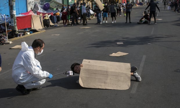 Một phóng viên đang phỏng vấn một người biểu tình ở thủ đô Lima (Peru) để phản đối chính sách cách ly của chính phủ, buộc người lao động nhập cư không được về quê nhà hôm 30/4/2020. Ảnh: AP
