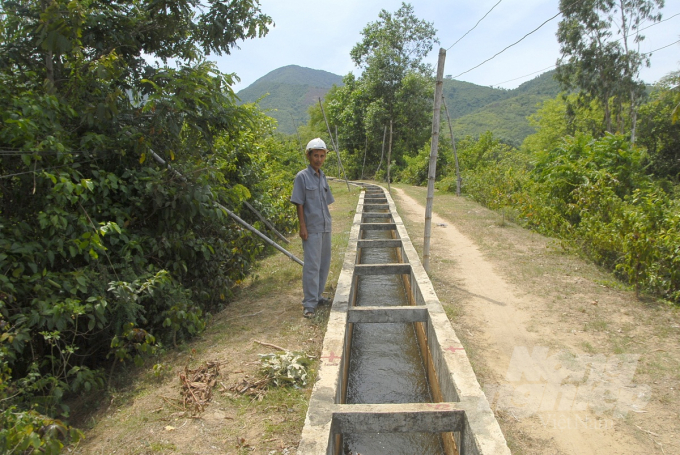 Nhân viên Công ty TNHH KTCTTL Bình Định dẫn nước tưới từ hồ Hội Sơn (huyện Phù Cát) về những cánh đồng trong vùng tưới. Ảnh: Vũ Đình Thung.