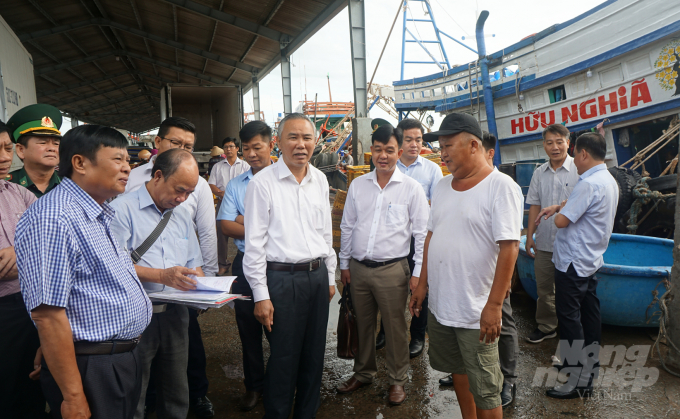 Thứ trưởng Bộ NN-PTNT Phùng Đức Tiến (đứng giữa) thăm hỏi ngư dân về thực hiện IUU. Ảnh: HĐ.