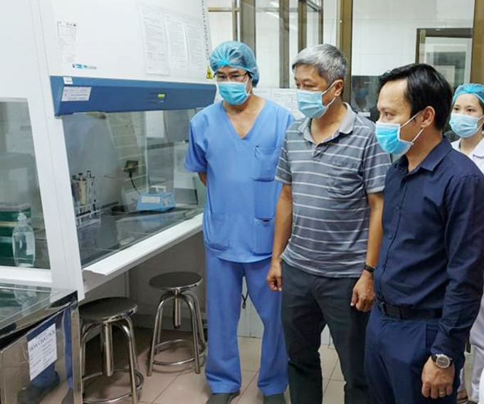 Thứ trưởng Bộ Y tế Nguyễn Trường Sơn kiểm tra quy trình vận hành phòng xét nghiệm do Viện Pasteur TP.HCM thiết lập tại Bệnh viện C Đà Nẵng. Ảnh: Anh Văn.