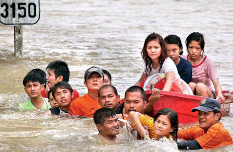 Người dân Thái bám vào dây thừng để chống chọi nước lũ hôm 25/10. Ảnh: nationmultimedia.com.