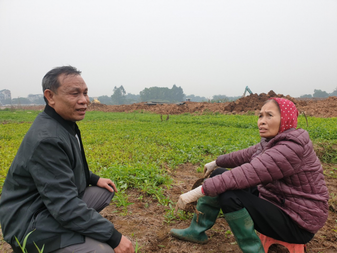 Ông Nguyễn Văn Định cùng trò chuyện với một hộ nông dân khác về việc chưa nhận được đền bù, hỗ trợ chuyển đổi nghề. Ảnh: Văn Việt. 
