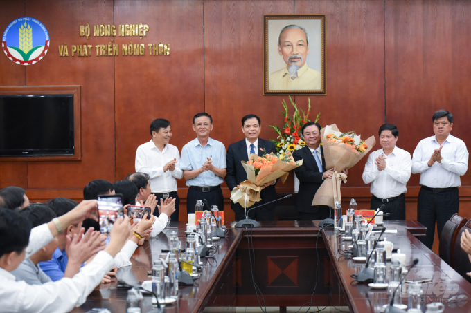 Tập thể lãnh đạo Bộ NN-PTNT tặng hoa chúc mừng ông Nguyễn Xuân Cường và ông Lê Minh Hoan. Ảnh: Tùng Đinh.