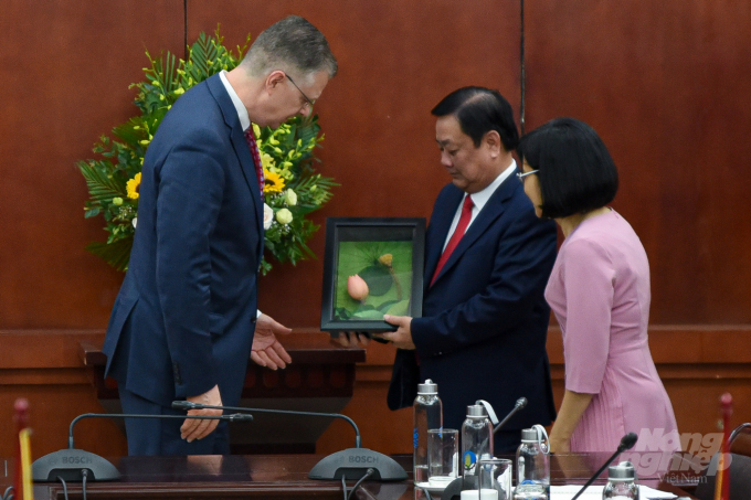 Bộ trưởng Lê Minh Hoan tặng Đại sứ Daniel Kritenbrink món quà kỷ niệm là sản phẩm làm từ sen Đồng Tháp. Ảnh: Tùng Đinh.