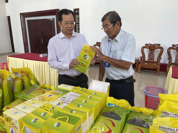 Phó Chủ tịch UBND tỉnh Sóc Trăng, ông Vương Quốc Nam (trái) và ông Hồ Quang Cua trao đổi về sản phẩm gạo ST25. Ảnh: Hữu Đức.