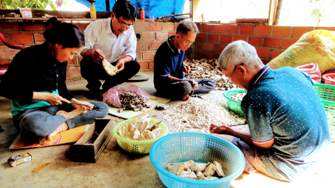 Những người thợ xoi xỉa trầm đang làm việc tại cơ sở chế tác trầm hương của anh Trần Văn Lộc. Ảnh: V.Đ.T.